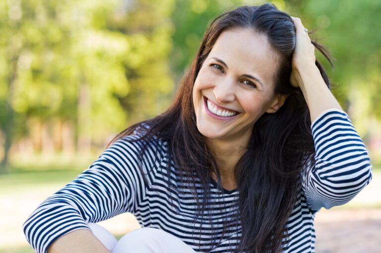 Happy Woman sitting in park